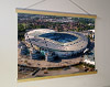 A 62cm / 24.4" poster hanger with 18x24" landscape print showing Aerial Photograph of Manchester City - Etihad Stadium